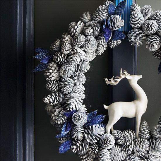 a snowy pinecone wreath with a deer and glitter blue touches
