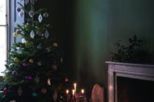 19 moody Christmas decor with bold vintage ornaments and a working fireplace