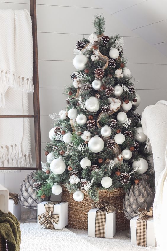 peaceful-looking Christmas tree with silver baubles, pinecones and burlap mesh