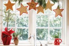 20 Christmas star-shaped cookies hanging from a branch