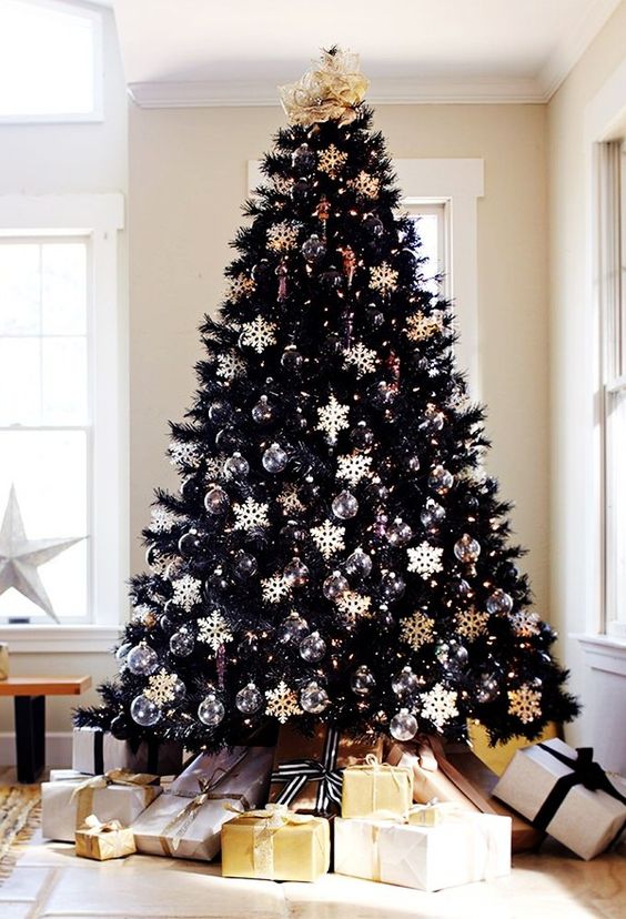chic black christmas tree with black and white ornaments all over makes a bold statement
