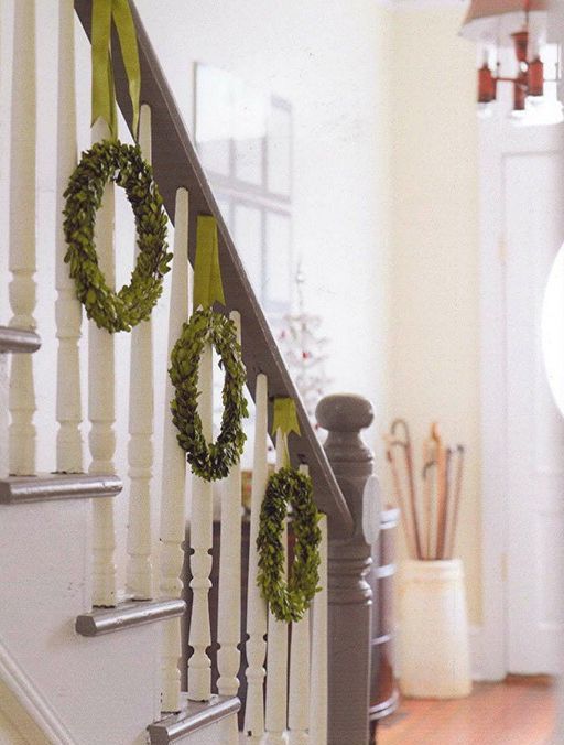green wreaths hanging from the banister