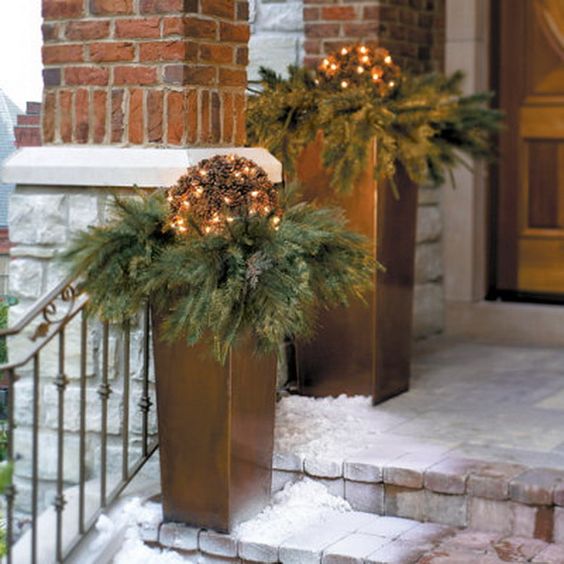 modern copper urns, fir branches, pinecones and lights
