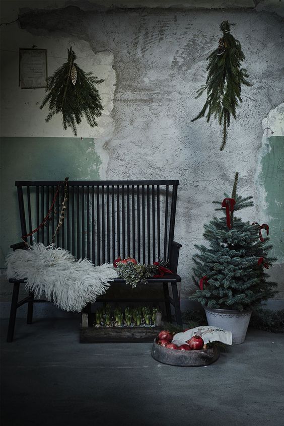 moody industrial space with evergreens, fur and pomegranates