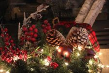 21 a basket with evergreens, berries, pinecones and lights
