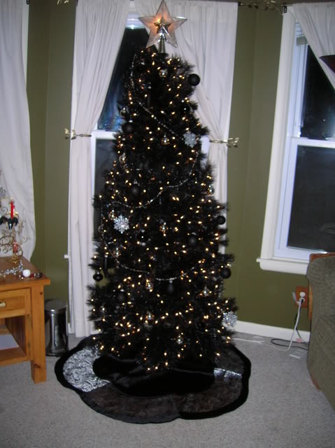 chic black tree with black ornaments and gold lights
