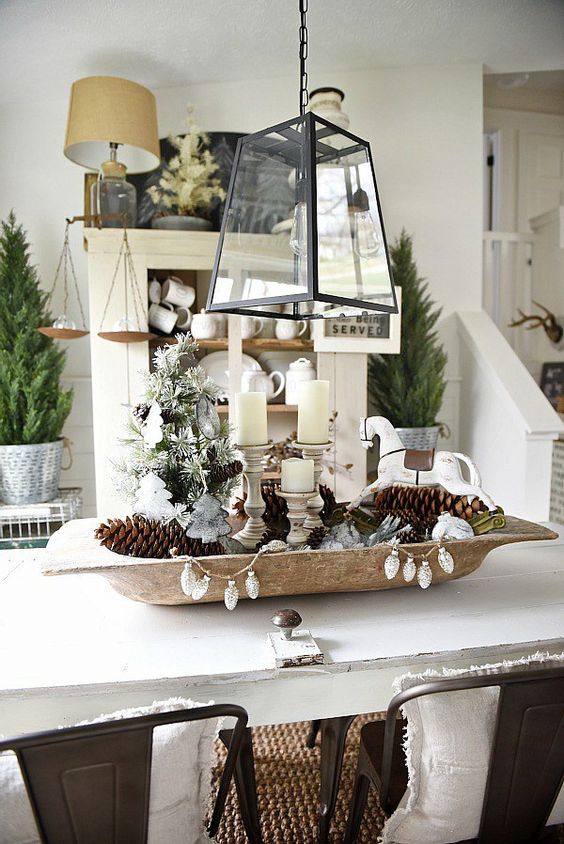 a dough bowl with pinecones, candles and vintage ornaments