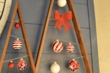 22 reclaimed wood plank christmas trees with ornaments hanging inside