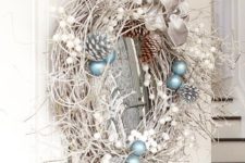22 snowy grapevine wreath with pinecones and blue ornaments