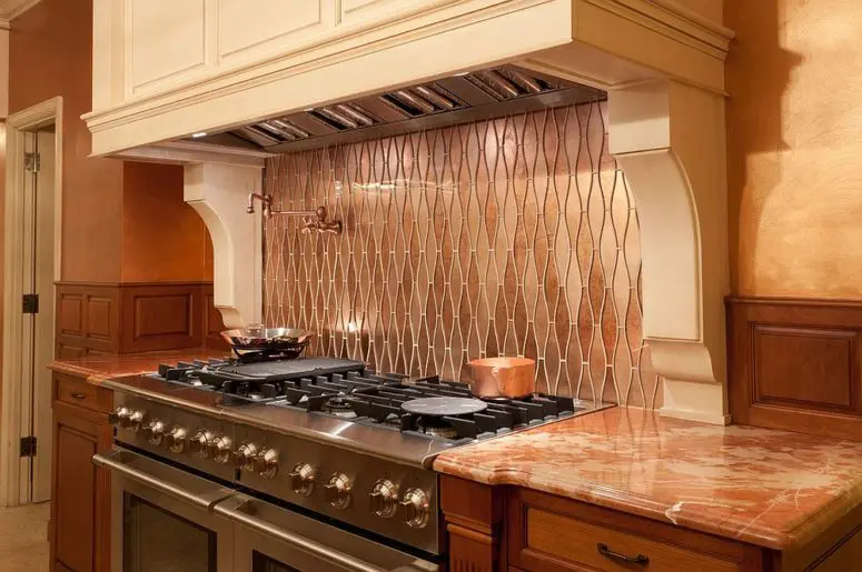small modern kitchen with custom copper backsplash that also adds pattern