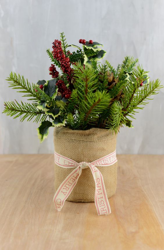 a burlap wrapped pot with evergreens, leaves and berries would be perfect addition to your Christmas staircase decor