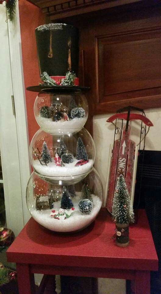 a snowman mad eof three glass terrariums filled with winter stuff is a whimsy idea