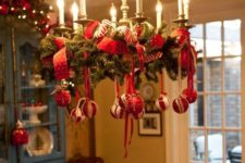 24 decorate a usual chandelier with evergreen branches, red ribbon and ornaments