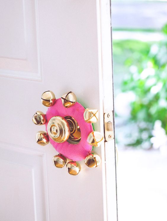 pink door knob hanger with gold jingle bells for a glam feel