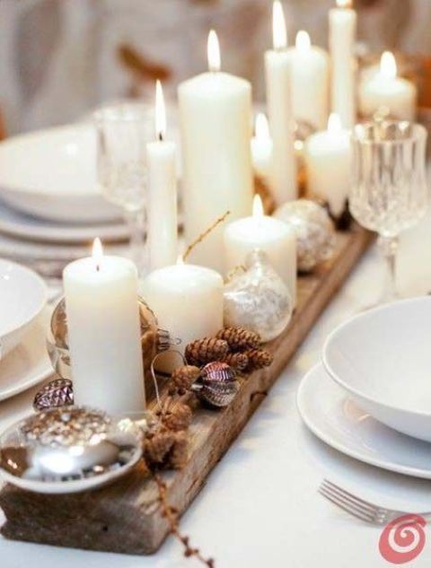 place a wooden plank on the table, cover it with pinecones and candles