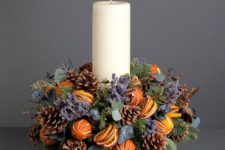 25 a cool centerpiece with a pillar candle, lavender, pinecones and citrus