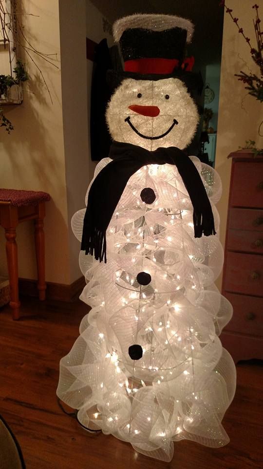 a tomato cage lit up snowman can be DIYed of lights and white mesh ribbon