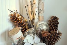 26 a galvanized bucket with branches, pinecones, ornaments and a poinsettia