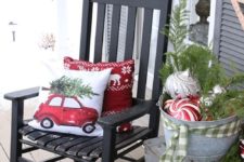 26 a rocker with pillows, a galvanized bathtub with evergreens and ornaments