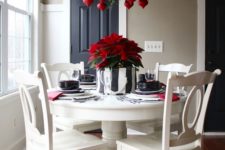 26 fern branches and seeral bold red ornaments echo with a green and red centerpiece