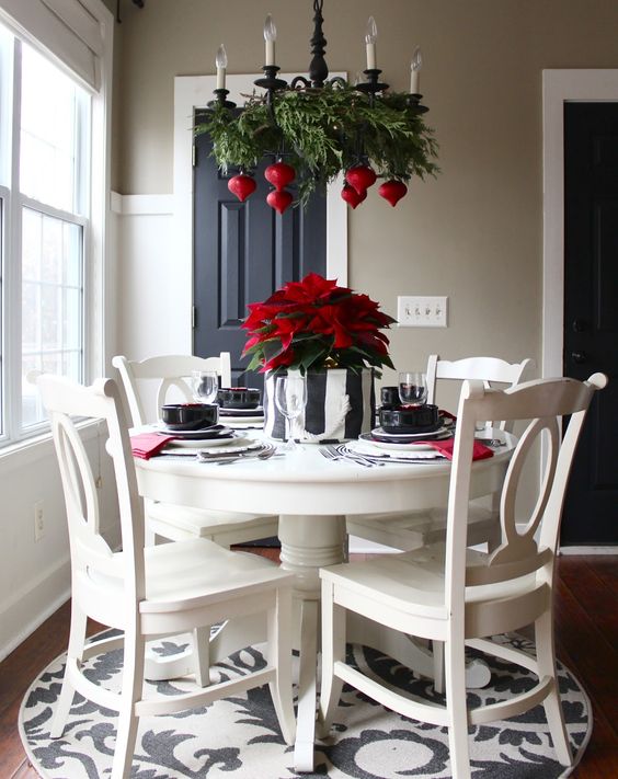 fern branches and seeral bold red ornaments echo with a green and red centerpiece