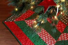 a traditional red and green Christmas tree skirt DIYed using patchwork technique is a super cool and bright idea for the holidays