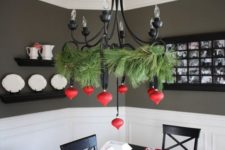 27 a black chandelier contrasts with red ornaments