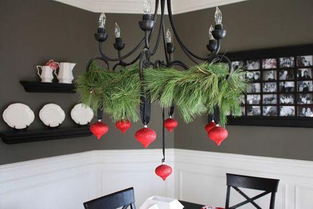 a black chandelier contrasts with red ornaments
