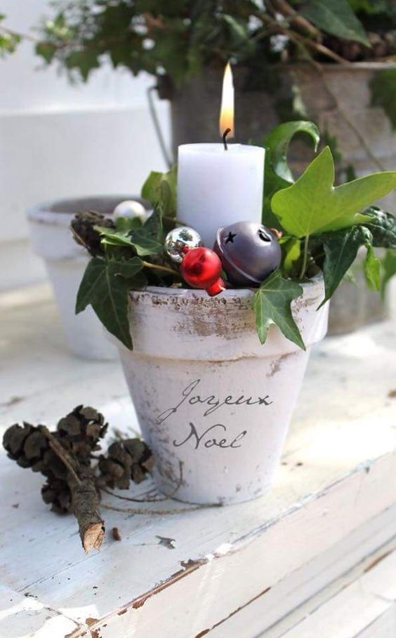 a planting pot with ornaments and a candle