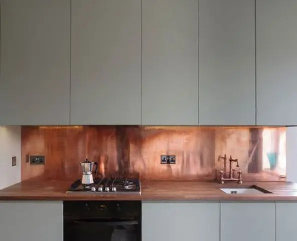 warm copper adds a sense of luxury to this kitchen