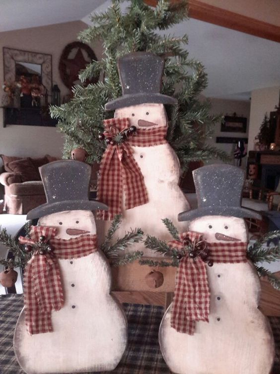 cutout snowmen trio holding a fir tree