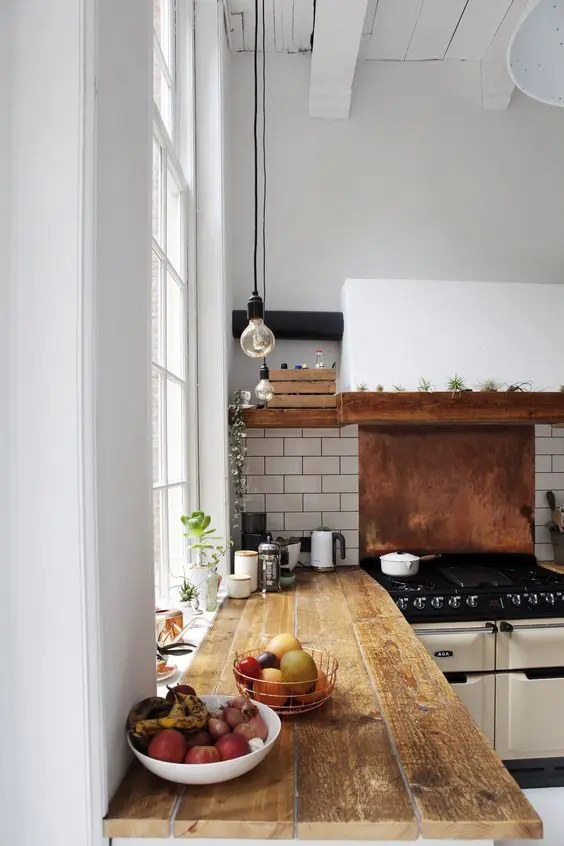 white subway tiles and a copper backsplash for the cooker