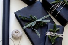 28 wrap gifts in black and add evergreen sprigs for a laconic yet festive look