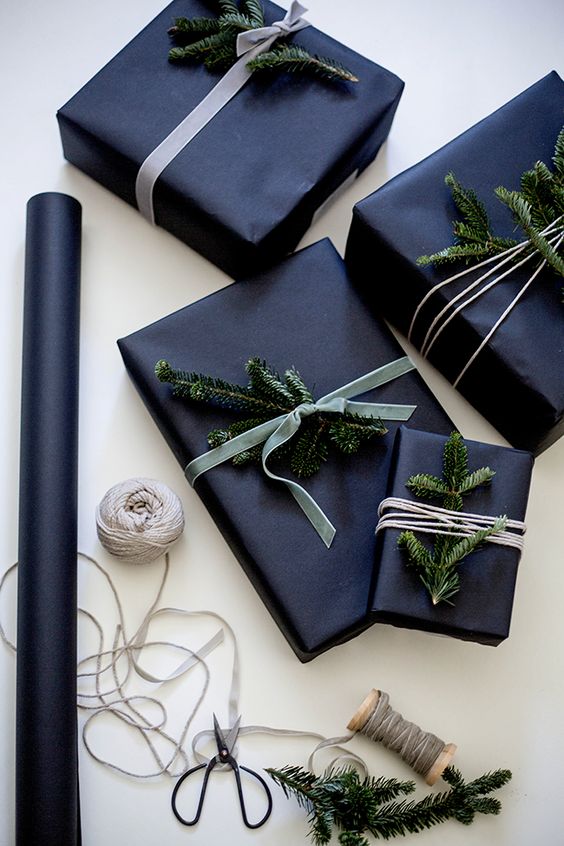 wrap gifts in black and add evergreen sprigs for a laconic yet festive look