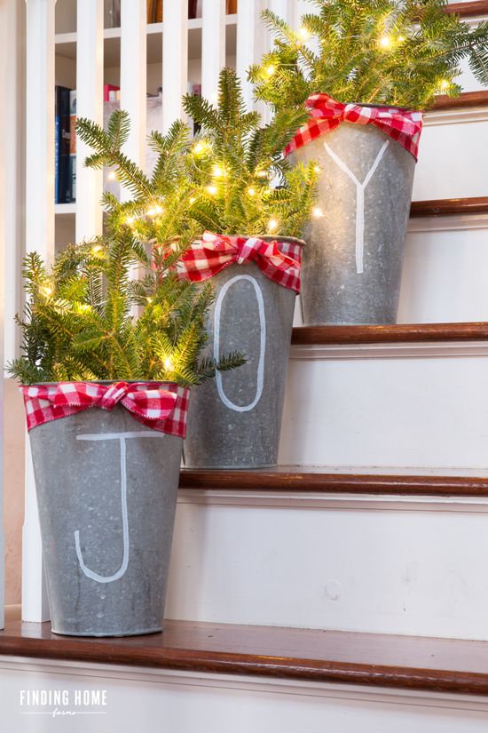 chalk pen galvanized buckets with fir branches and lights