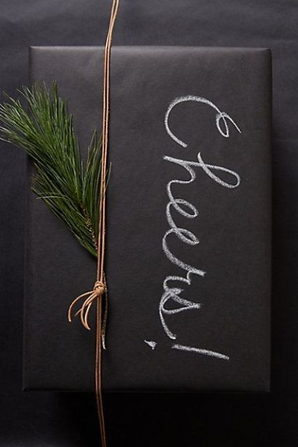 chalkboard gift wrapping with evergreens and chalk writing