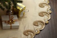 a refined champagne-colored tree skirt with gold embroidery and rhinestones will be a great accent for a sophisticated and glam Christmas tree