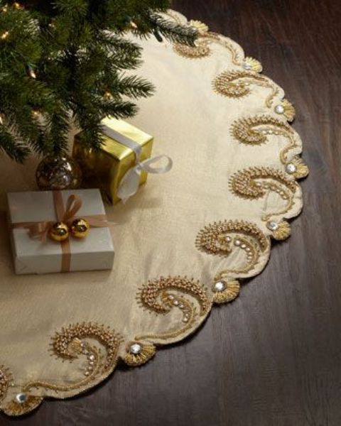 A refined champagne colored tree skirt with gold embroidery and rhinestones will be a great accent for a sophisticated and glam Christmas tree