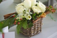 30 a tiny basket arrangement with candles, flowers and cinnamon sticks