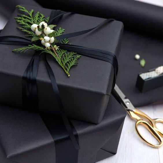 charcoal grey wrapping paper, black ribbon and fresh greenery
