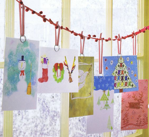 hang cards on a pompom thread next to the window