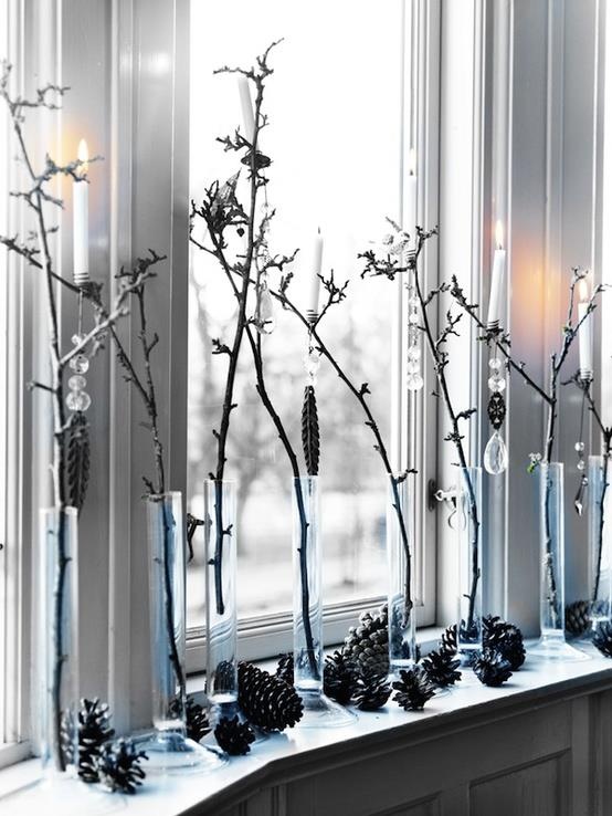 branches in tube vases and pinecones for rustic window decor