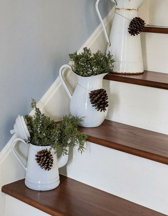 fresh juniper in vintage enamelware placed right on the stairs