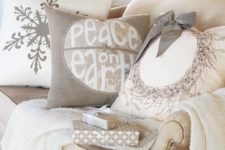 32 a neutral throw and neutral pillows with winter patterns