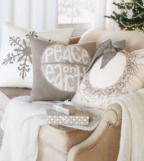 a neutral throw and neutral pillows with winter patterns