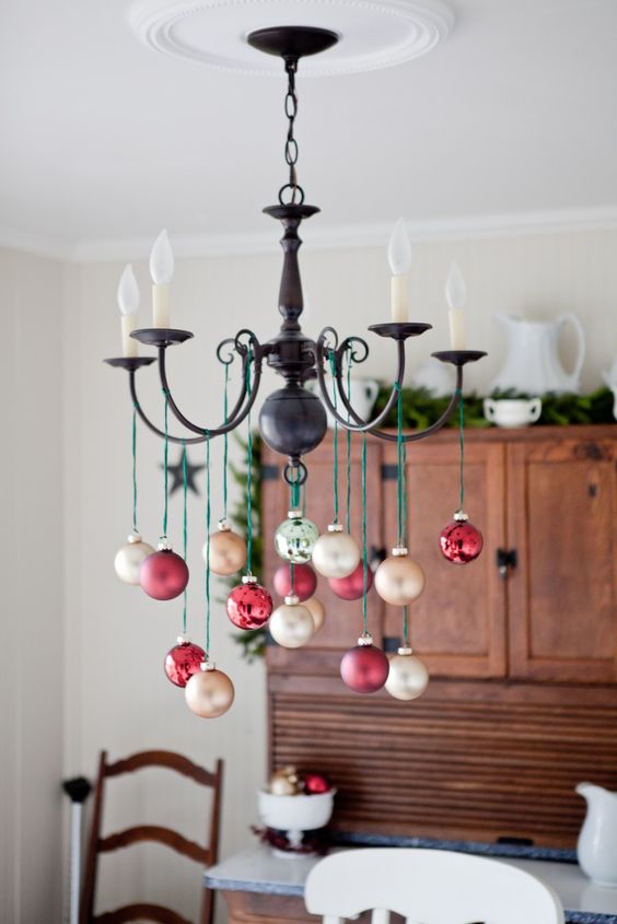 take champagne and red ornaments and hang them on green twine