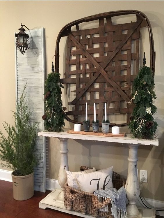 a tobacco basket, evergreens, candles and moss is right what you need for an organic winter entryway