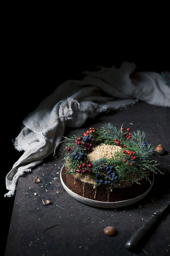 traditional Christmas cake withevergreens and berries