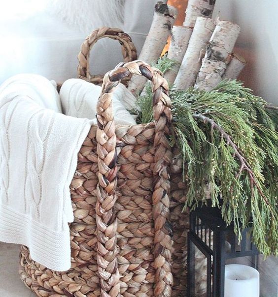 birch logs, greens and a throw in a basket