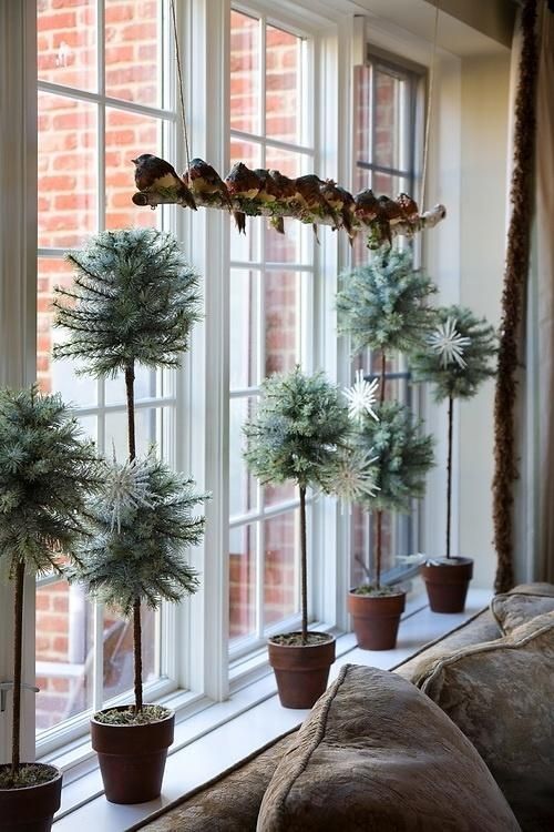 pale potted greenery and faux birds on a branch display